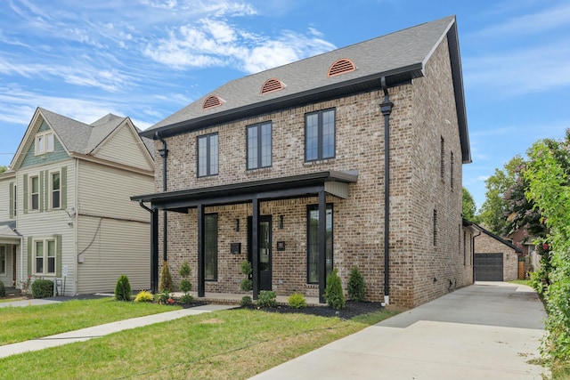 view of front of home with a garage and a front lawn