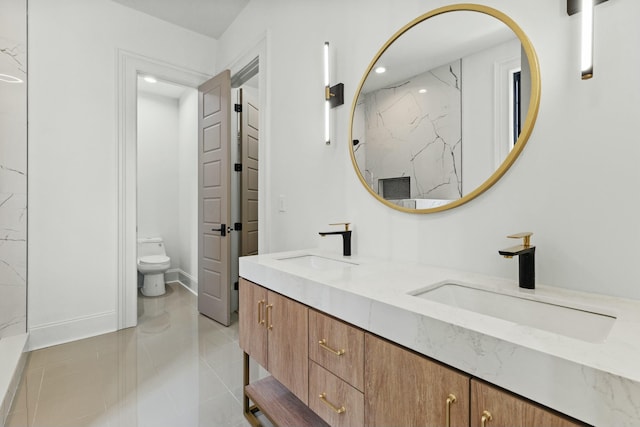 bathroom with tile patterned flooring, vanity, and toilet