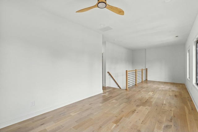 unfurnished room with light wood-type flooring and ceiling fan