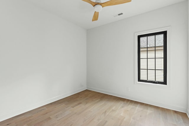 empty room with plenty of natural light, ceiling fan, and light wood-type flooring