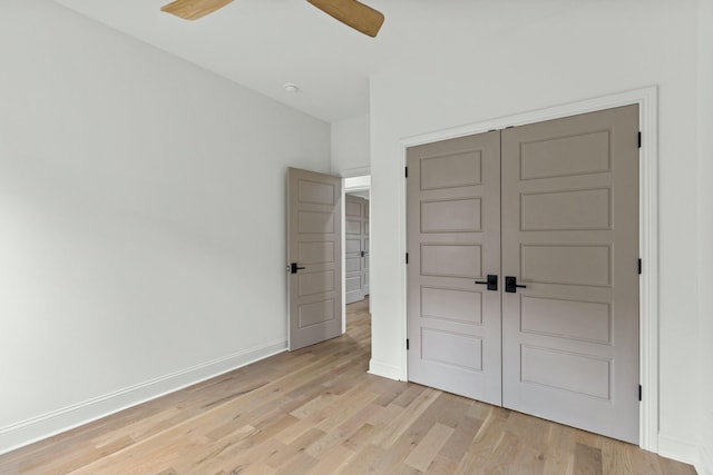 unfurnished bedroom with light wood-type flooring, a closet, and ceiling fan