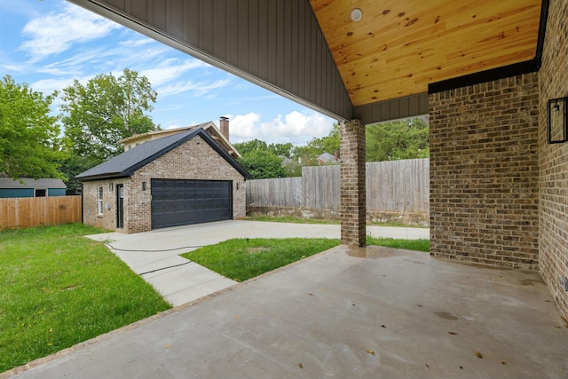 view of patio with an outdoor structure and a garage