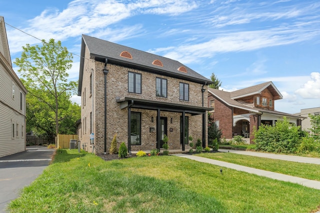 view of front facade featuring central air condition unit and a front lawn