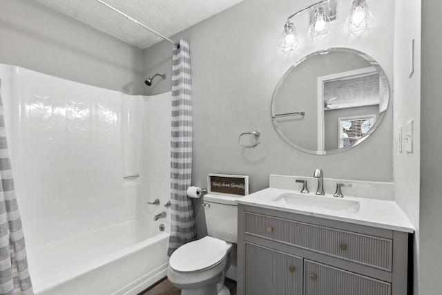 full bathroom with toilet, a textured ceiling, shower / bath combo, and vanity