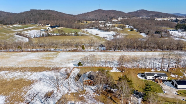 snowy aerial view with a mountain view