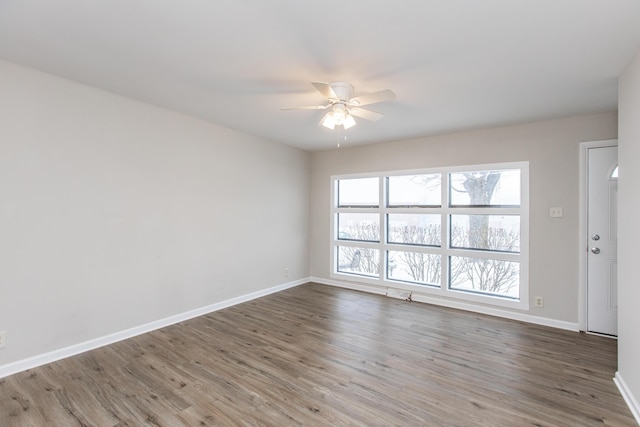 empty room featuring hardwood / wood-style floors and ceiling fan