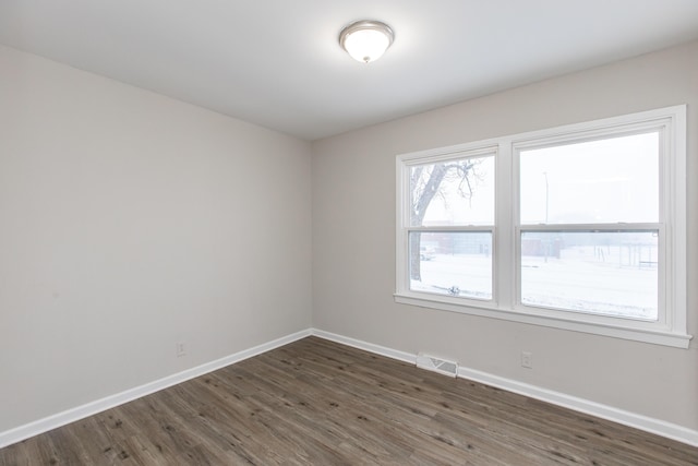 spare room with dark hardwood / wood-style flooring