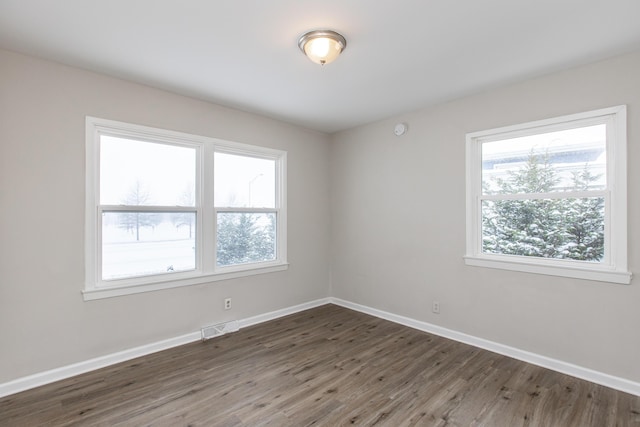 spare room featuring dark hardwood / wood-style floors