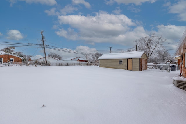 snowy yard with an outdoor structure