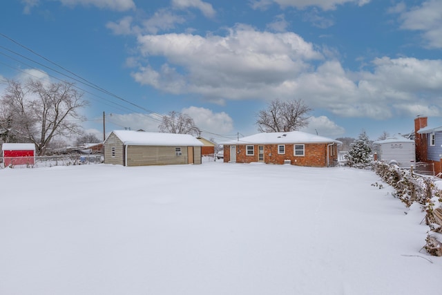 view of snow covered back of property