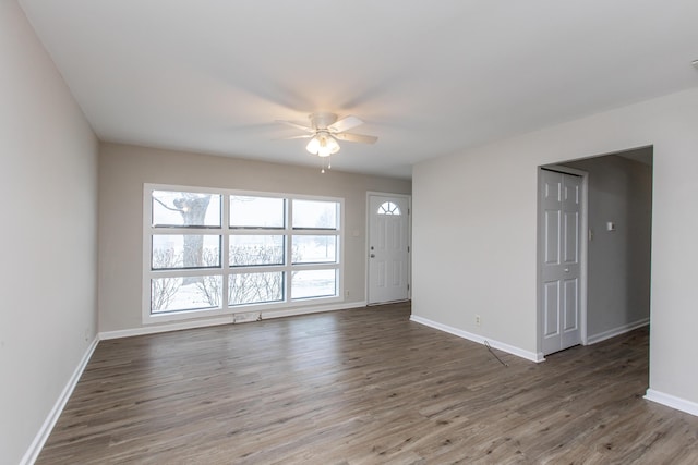 spare room with ceiling fan and dark hardwood / wood-style floors