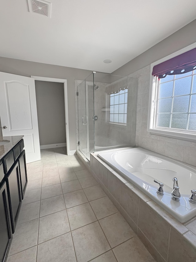 bathroom featuring tile patterned floors, vanity, and shower with separate bathtub