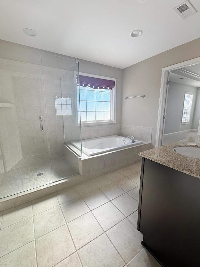 bathroom featuring separate shower and tub, vanity, and tile patterned flooring