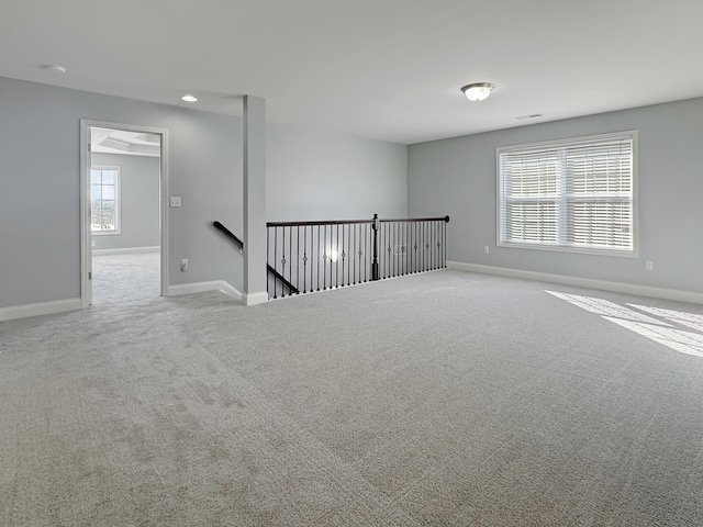 unfurnished room featuring light carpet