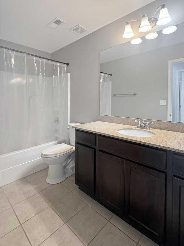 full bathroom with shower / tub combo with curtain, toilet, vanity, and tile patterned floors