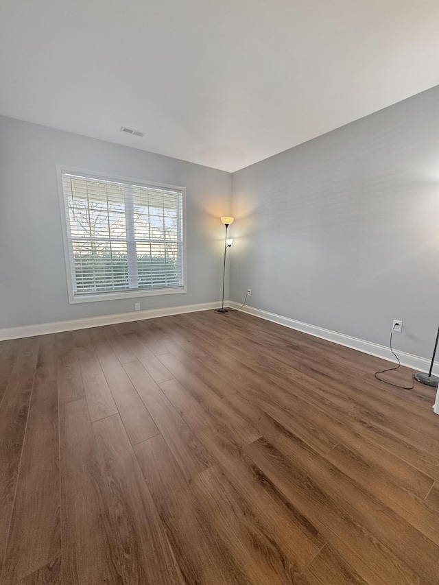 empty room with dark wood-type flooring