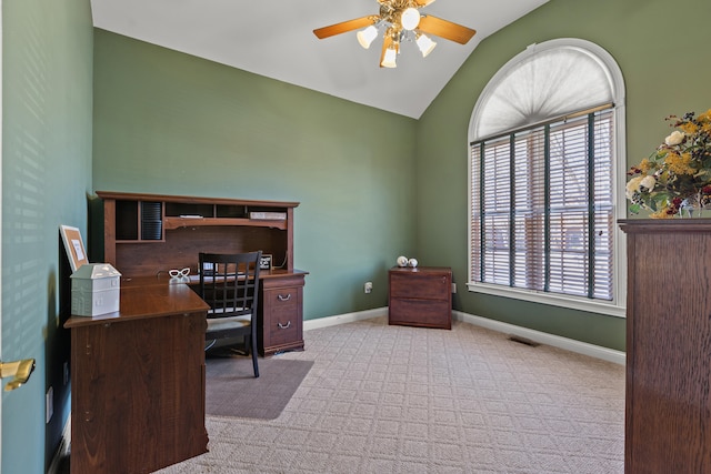 home office featuring light carpet, vaulted ceiling, and ceiling fan