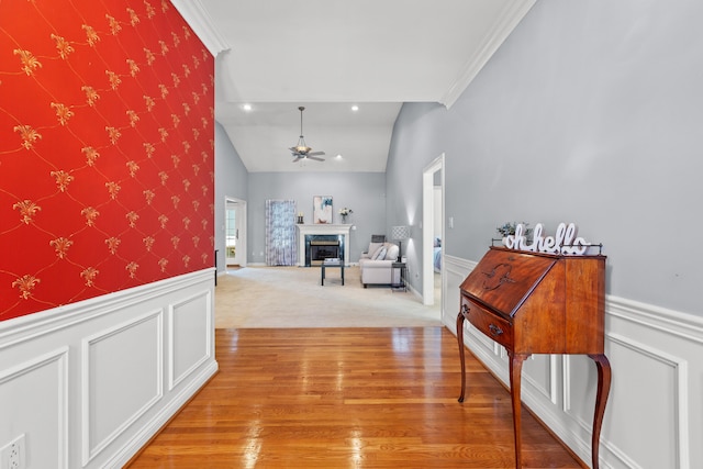 hallway featuring crown molding, vaulted ceiling, and carpet floors