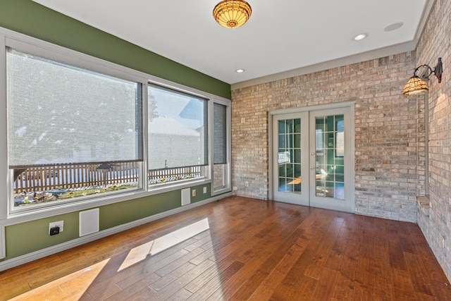 unfurnished sunroom with french doors and a healthy amount of sunlight