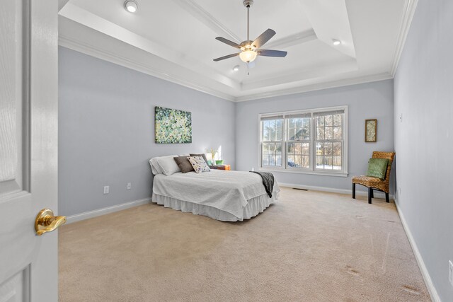 bedroom with a raised ceiling, crown molding, light carpet, and ceiling fan