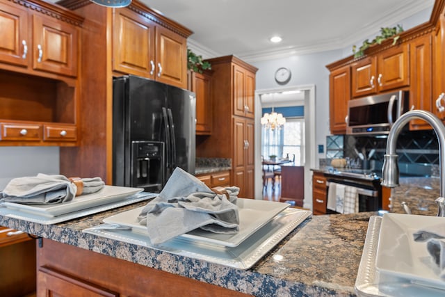 kitchen with crown molding, black fridge with ice dispenser, and a chandelier