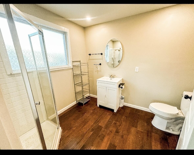 bathroom featuring vanity, hardwood / wood-style flooring, toilet, and an enclosed shower