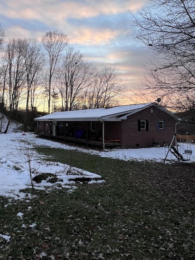 view of snow covered back of property