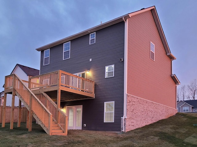 back of property featuring a deck and a yard