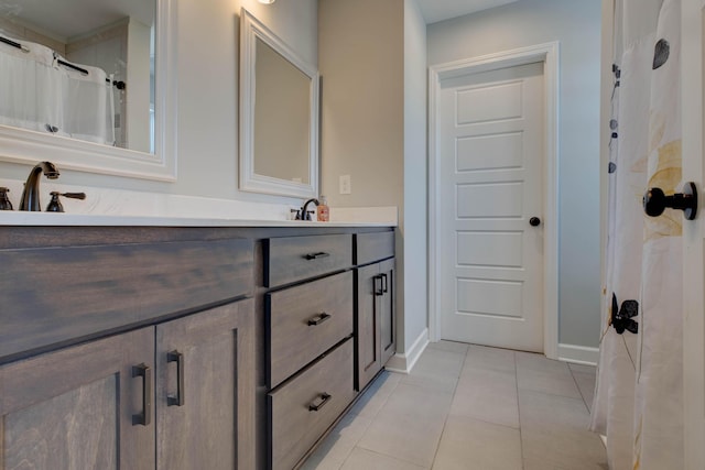 bathroom featuring tile patterned flooring and vanity