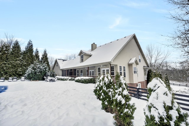 snow covered property featuring covered porch