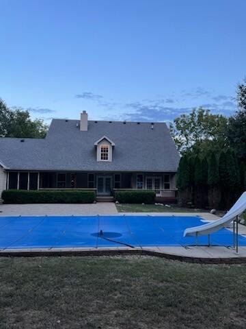 view of swimming pool featuring a yard and a water slide