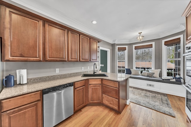 kitchen featuring kitchen peninsula, stainless steel dishwasher, ornamental molding, sink, and light hardwood / wood-style floors