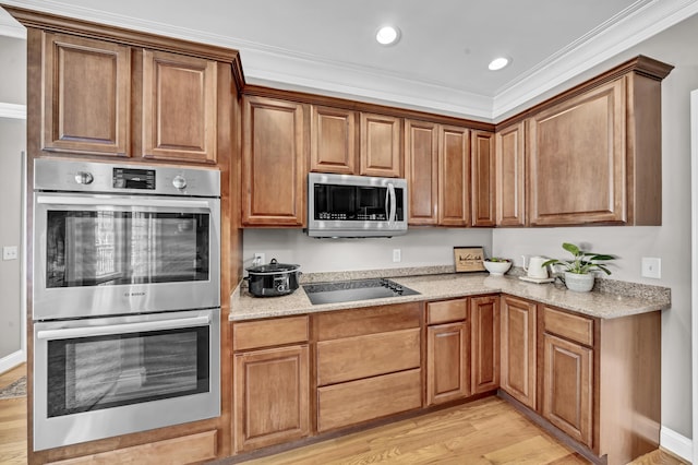 kitchen with crown molding, light hardwood / wood-style flooring, light stone countertops, and appliances with stainless steel finishes