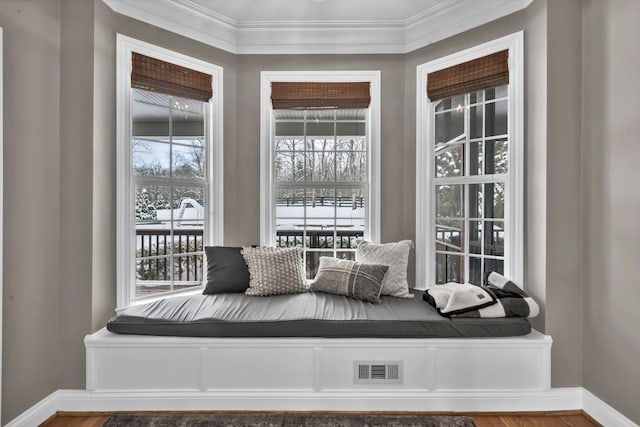 sitting room with crown molding and hardwood / wood-style floors