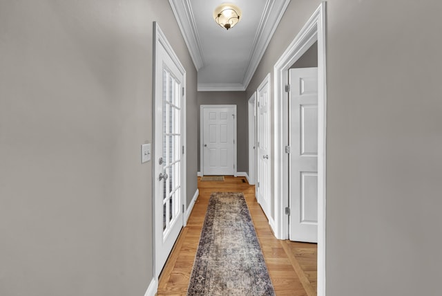 doorway to outside featuring light hardwood / wood-style flooring and ornamental molding