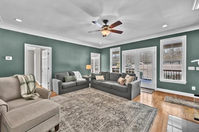 living room featuring ceiling fan, french doors, light hardwood / wood-style floors, and ornamental molding