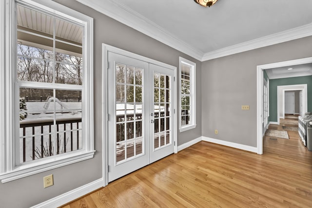 entryway featuring french doors, light wood-type flooring, and ornamental molding