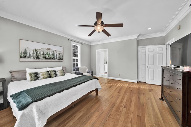 bedroom with ceiling fan, light wood-type flooring, crown molding, and a closet