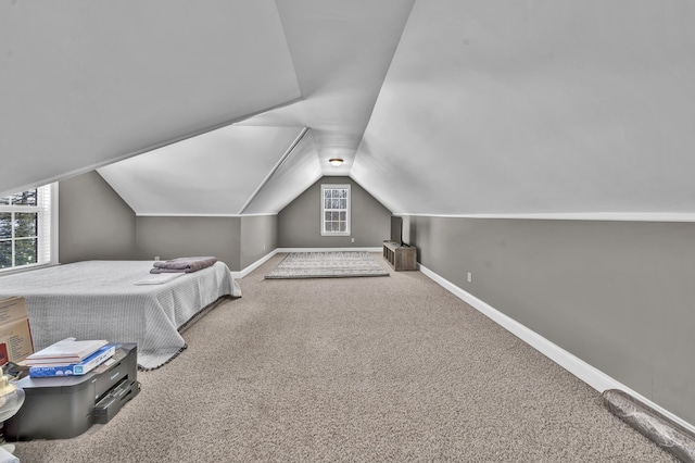 bedroom with carpet and lofted ceiling