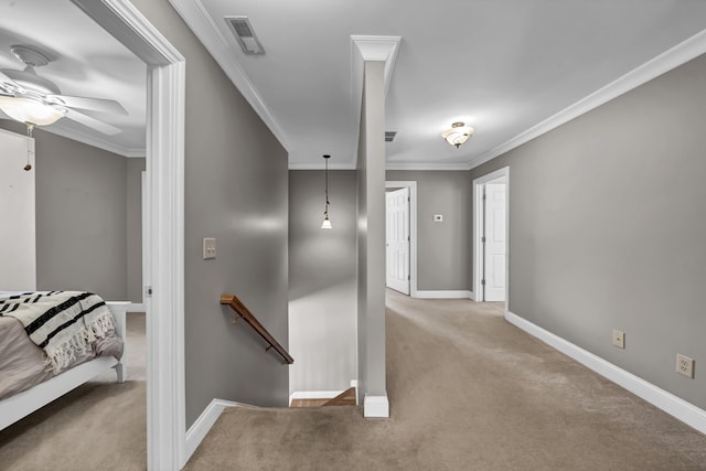 corridor with crown molding and light carpet