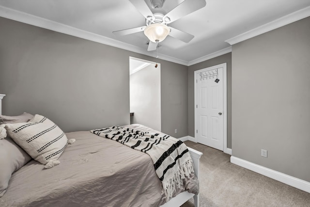 carpeted bedroom with ceiling fan and ornamental molding