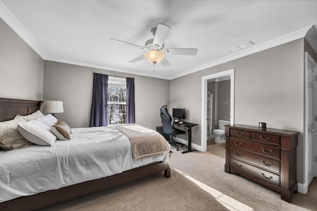 bedroom featuring ceiling fan, crown molding, light carpet, and ensuite bath