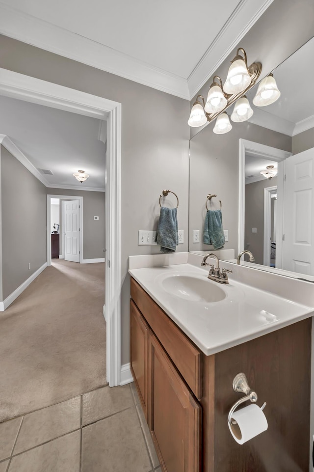 bathroom featuring tile patterned flooring, vanity, and crown molding