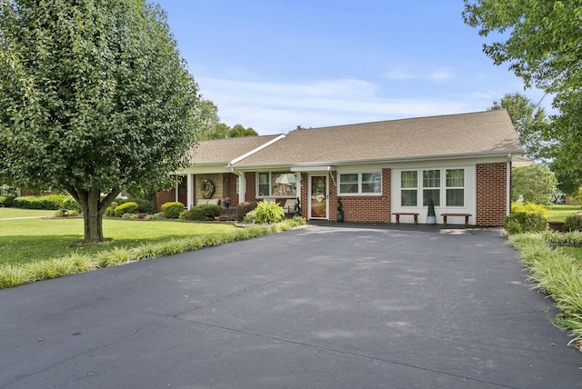 ranch-style home featuring a front lawn