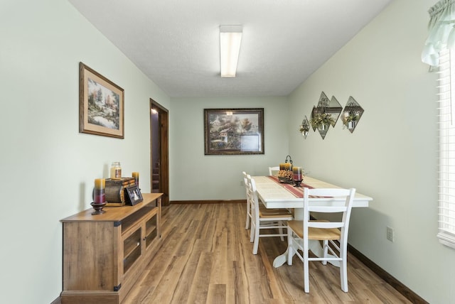 dining space with hardwood / wood-style floors