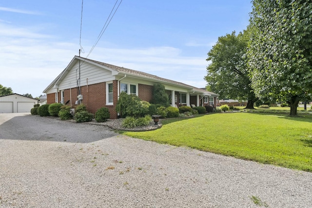 view of side of home with a yard, a garage, and an outdoor structure