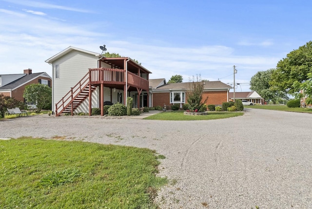 view of front of home featuring a front yard and a deck