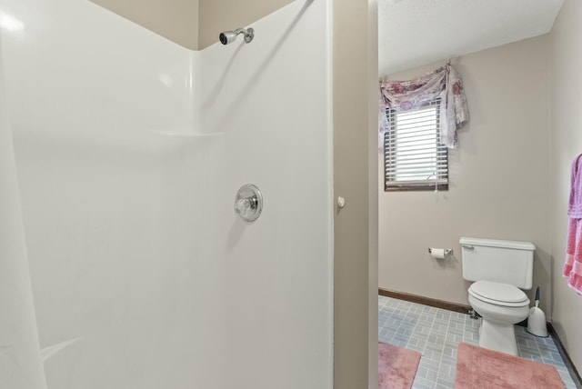 bathroom featuring toilet and a shower