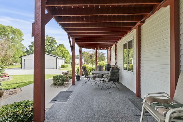 view of patio featuring an outbuilding and a garage