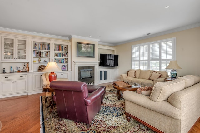 living room featuring crown molding and light wood-type flooring